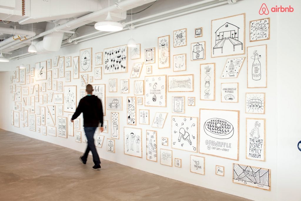 Decorative wall with illustrations of shared employee experiences